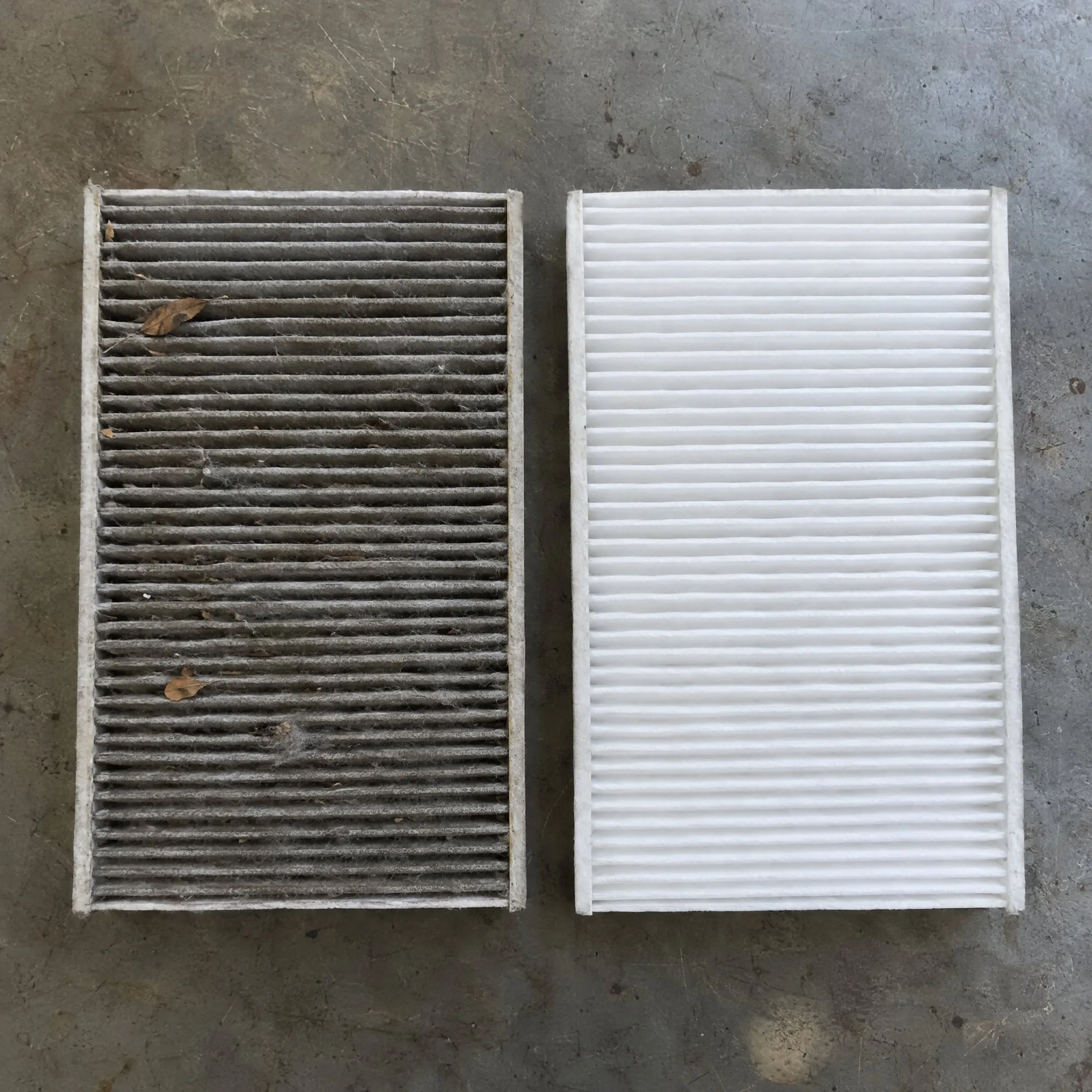 Dirty, clogged cabin air filter next to a clean new filter