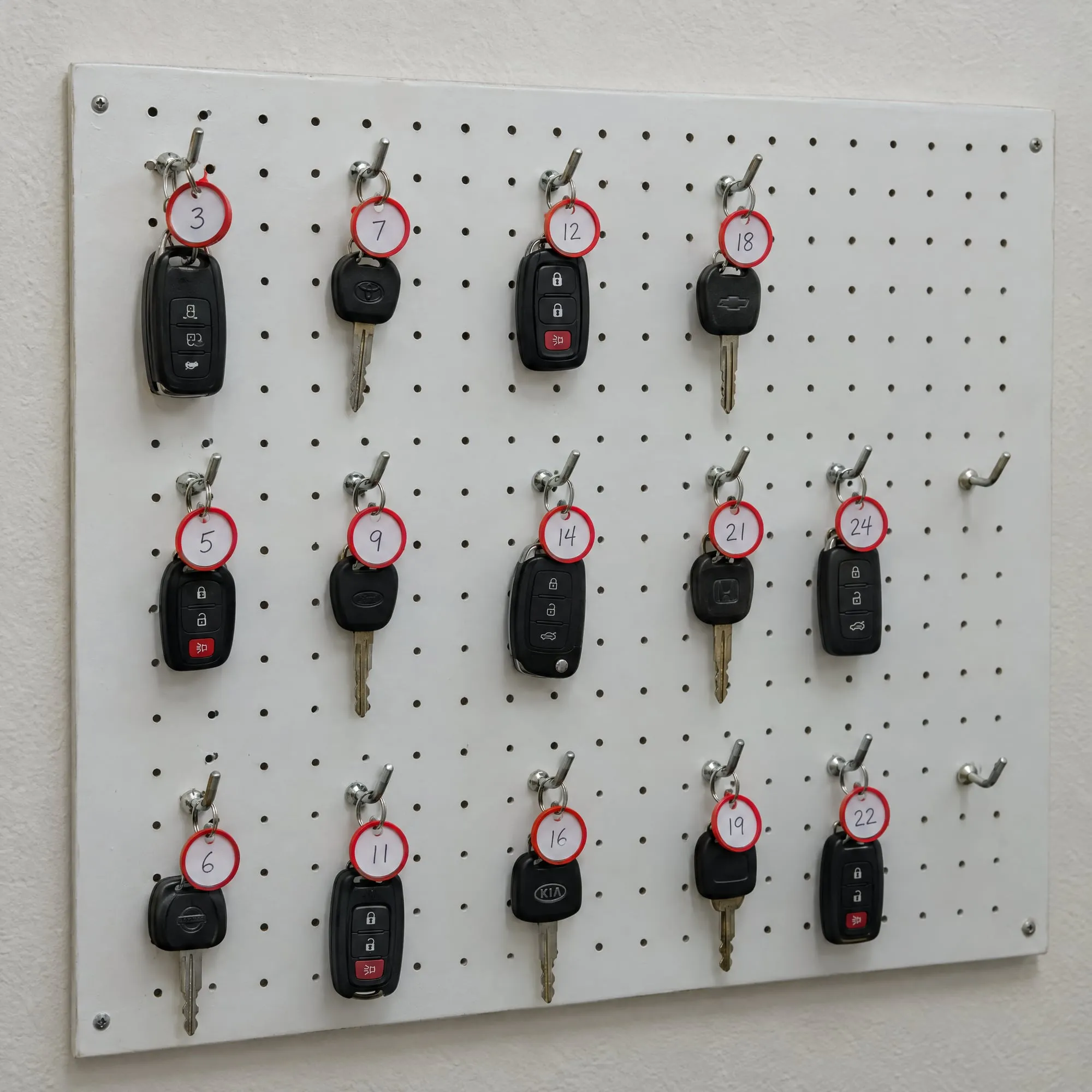 Customer keys hanging on a numbered key board in the shop office