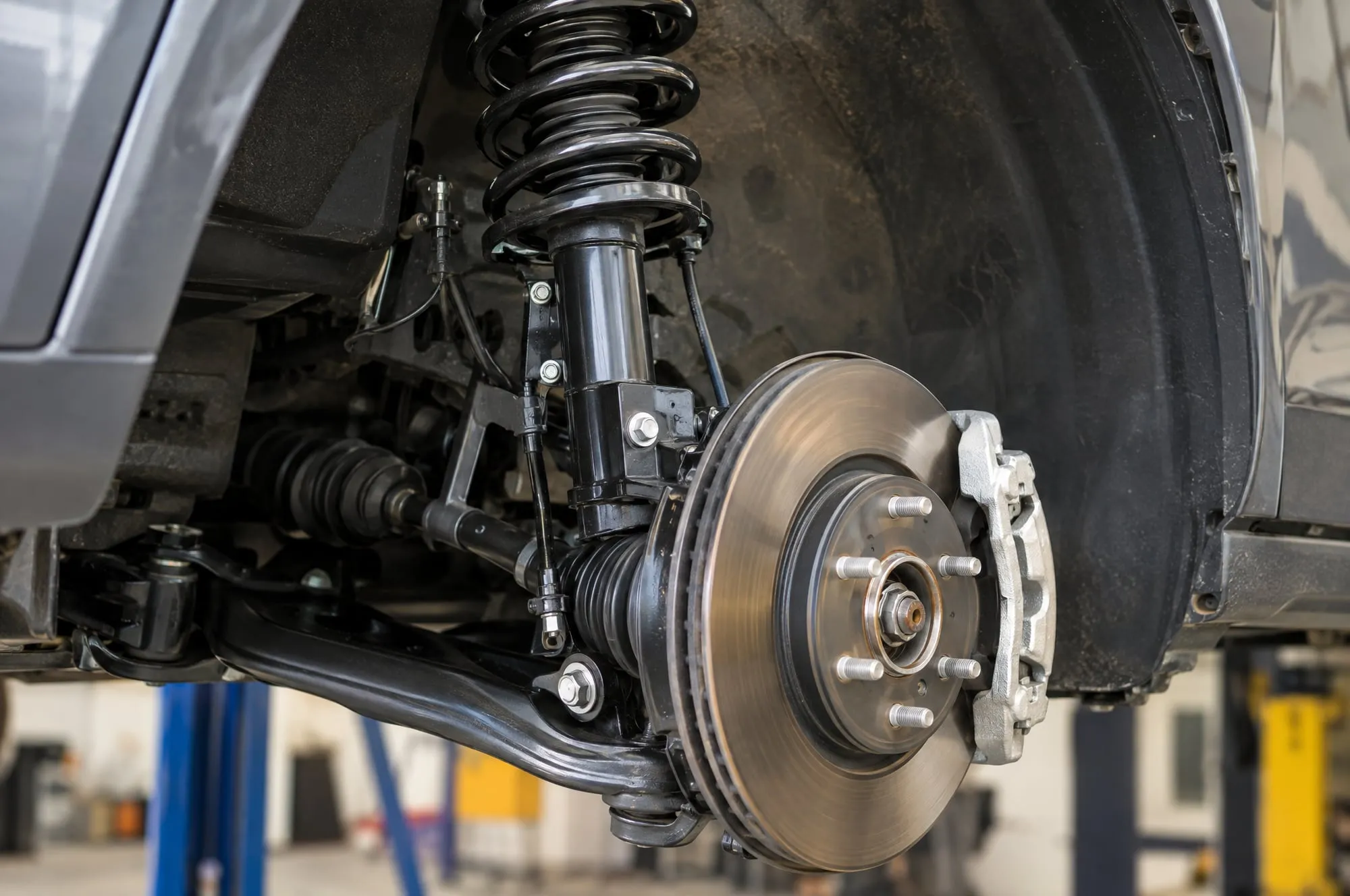 Strut and coil spring on a vehicle with the wheel removed