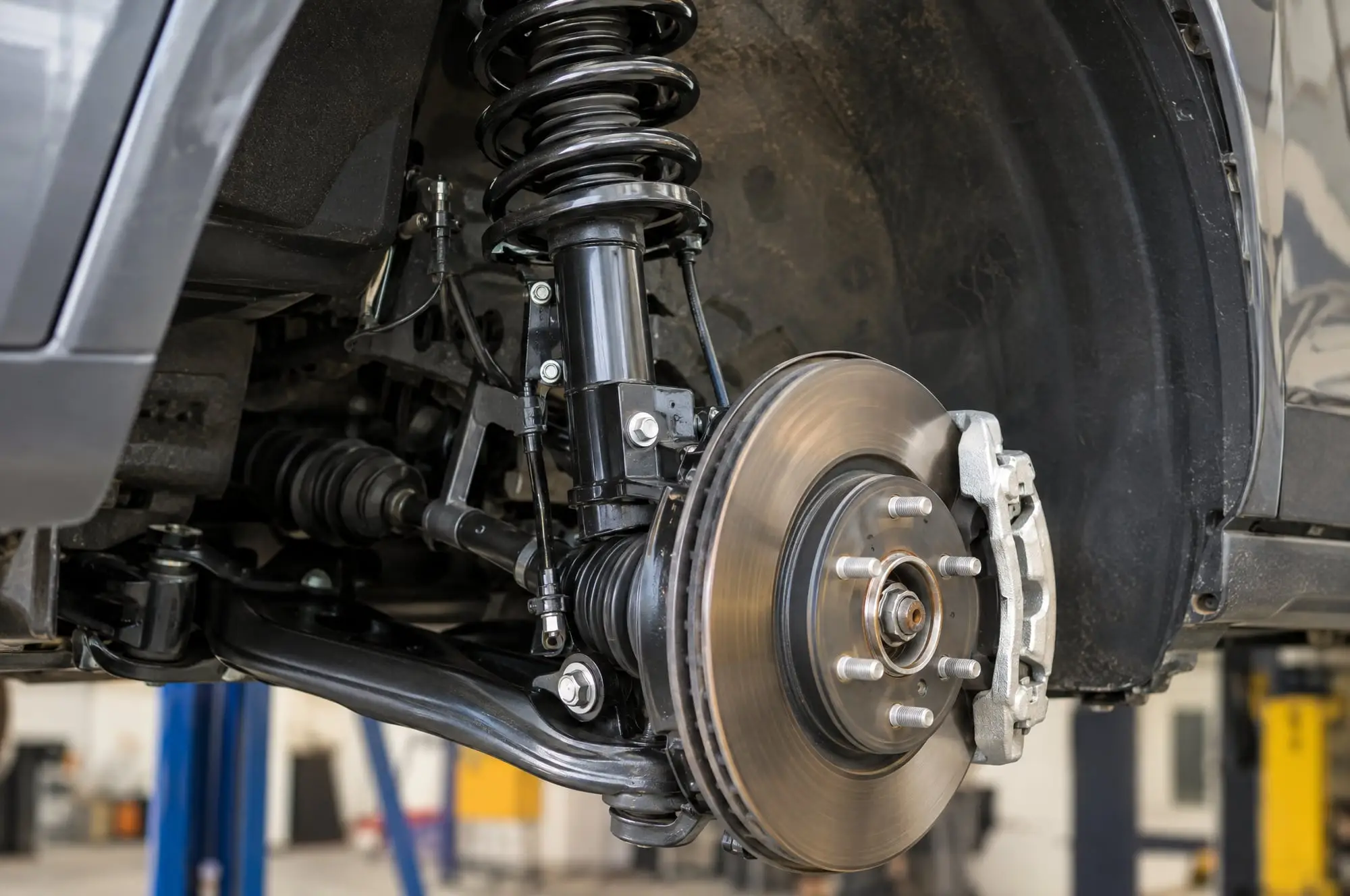 Strut and coil spring on a vehicle with the wheel removed